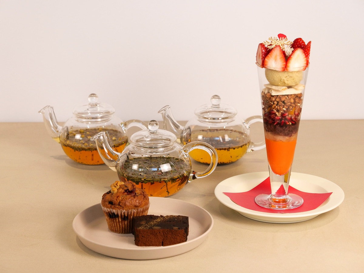 左から、季節のマフィン「ベリーとくるみのソイマフィン」（450円）、季節のガトーショコラ「柑橘と黒豆のガトーショコラ」（660円）、季節のパフェ「BEAUTY YAKUZENパフェ」（2530円）、後列は薬膳茶（各種770円）※全て税込（筆者撮影）