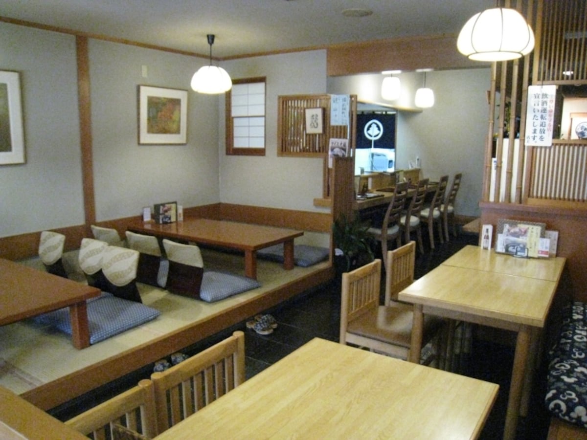 カウンター、小上がり、テーブル席と揃った店内。