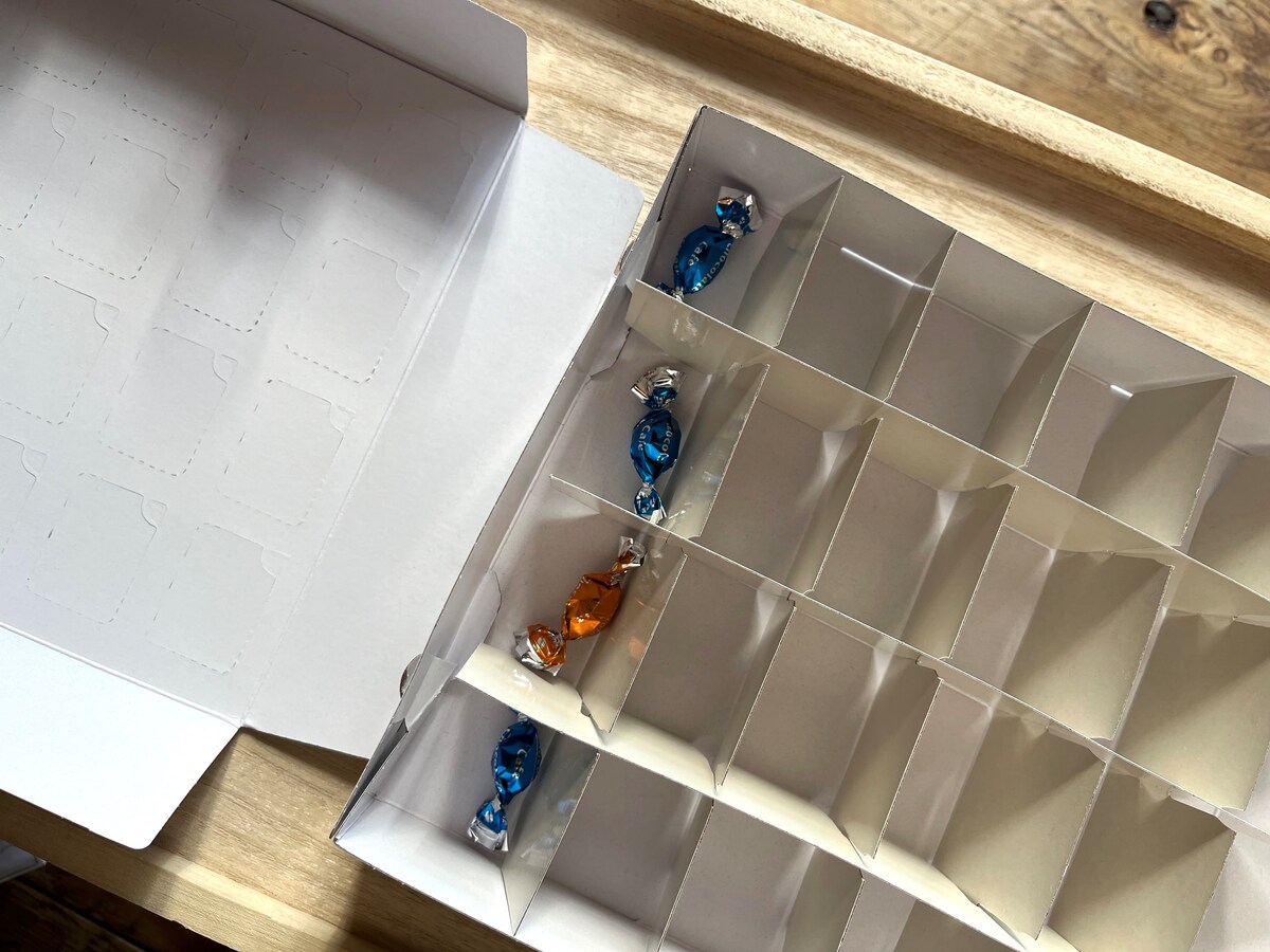 仕切りを入れた下の箱にお菓子などを入れていく