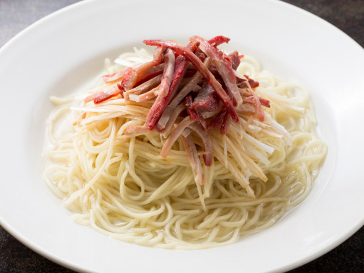 創業当時からあるメニュー、汁なしネギそば（干労麺：コンローメン、735円）。ひたひたのスープにつかっていて、よく混ぜていただきます（撮影：小林恵介）