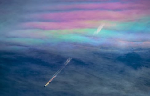 Rainbow Contrails Created by Cloud Iridescence
