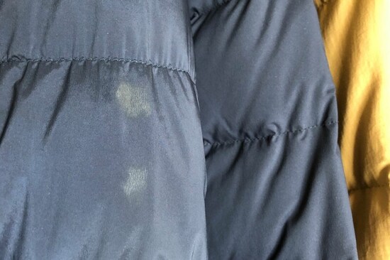 クリーニングに出さずに収納したダウンジャケット。袖には、着用時には気にならなかった汚れがくっきり（All About 編集部提供）