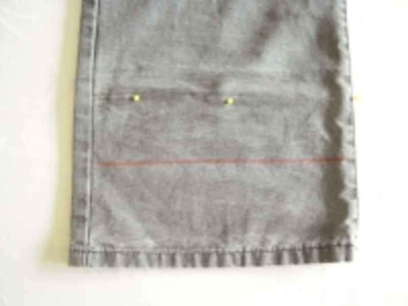 マチ針の箇所が出来上がりの位置。下側に縫い代を3～4cmとって線を引き、その線で丈をカットします