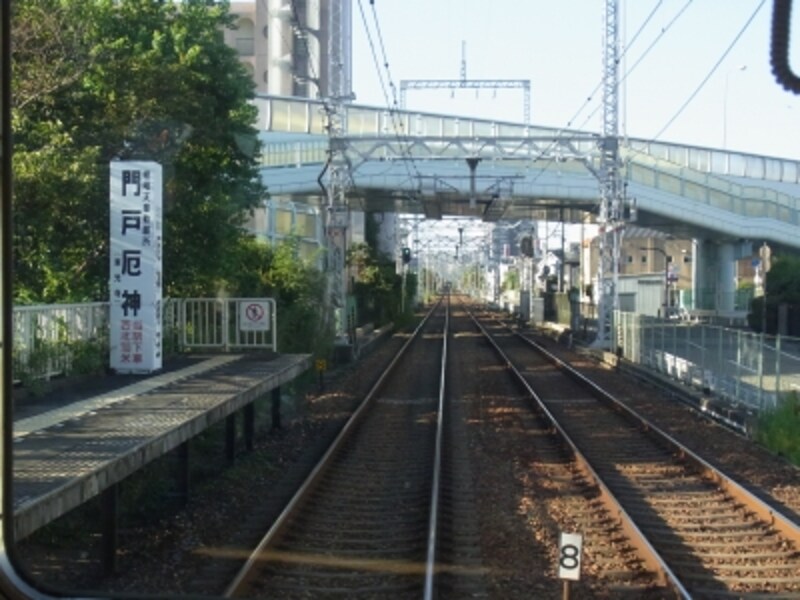 ホーム南端にある門戸厄神の看板。正面は国道１７１号線の高架。