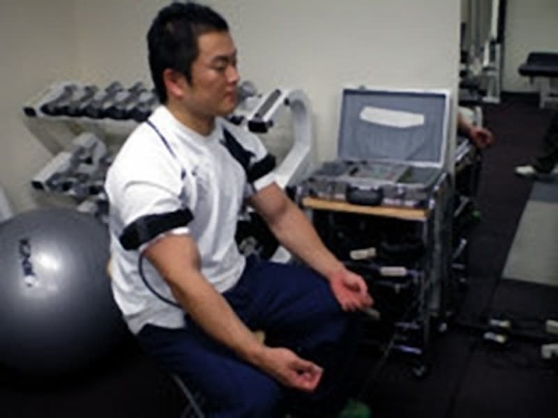 加圧ベルトを腕の付根に巻き、装置で締めていきます