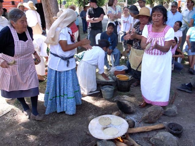 昔ながらのやり方で、手でたたくようにトルティージャを成形する女性たち