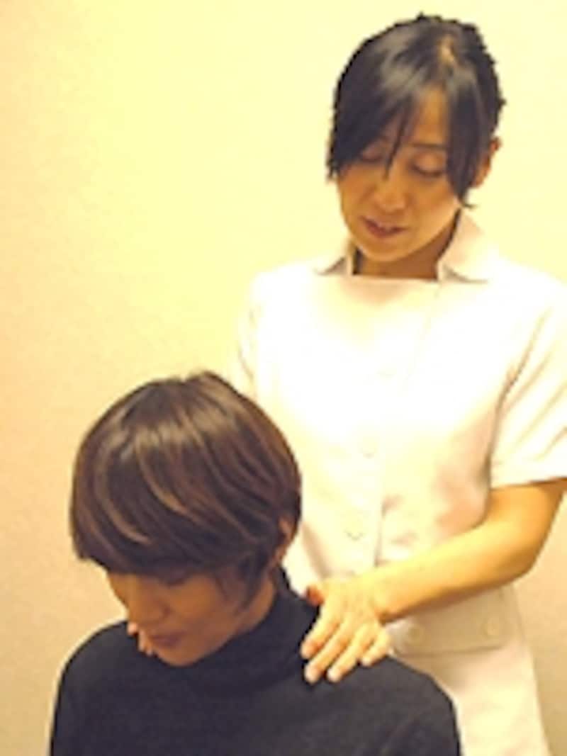 肩をさするように
