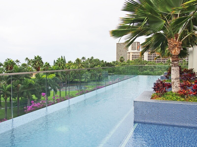 公園越しのビーチとつながって見えるインフィニティプール。プール、サンデッキともにエレガントな雰囲気