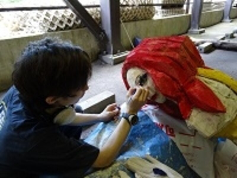 駐車場で制作を行う彫刻家の飯沼英樹さん