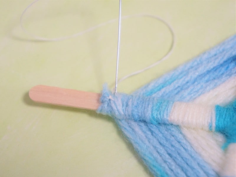 ゴッドアイ作り方　毛糸の先が出てこないように糸で縫い付けます。