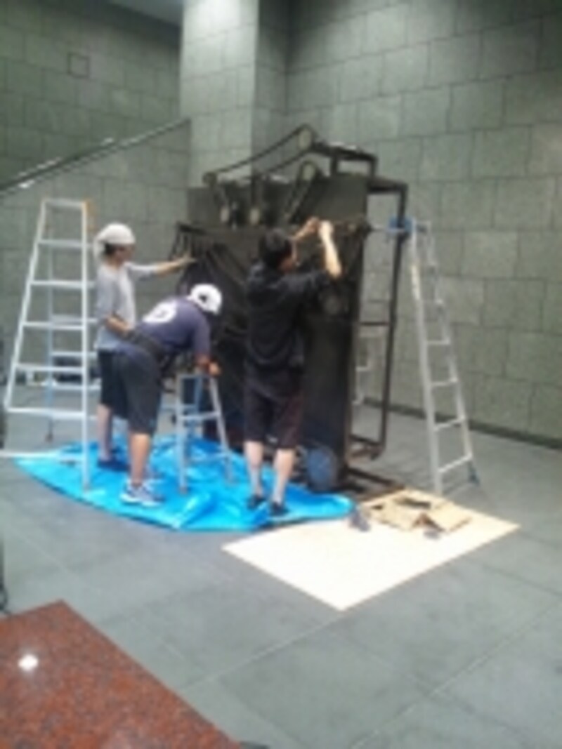 作品の設置をするタムラサトルさん