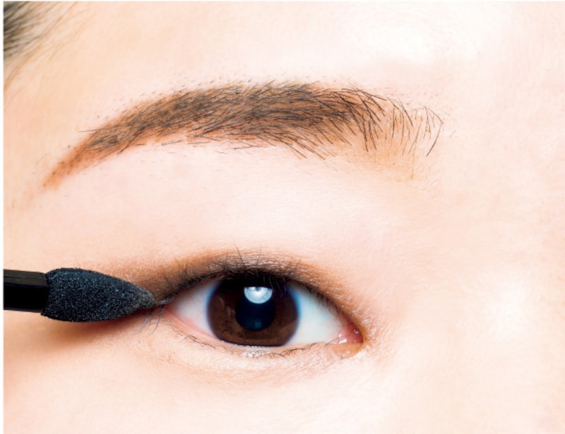 目を開いた状態でブラウンのアイシャドウを塗り足す