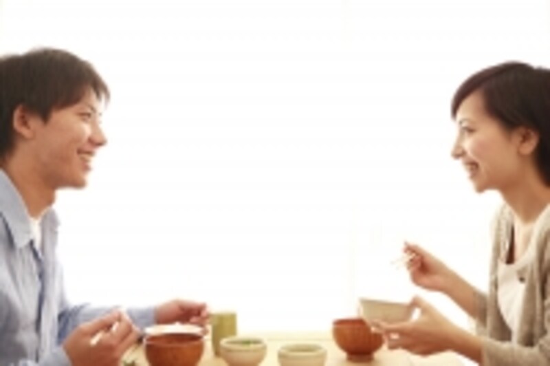向き合って座っている男女