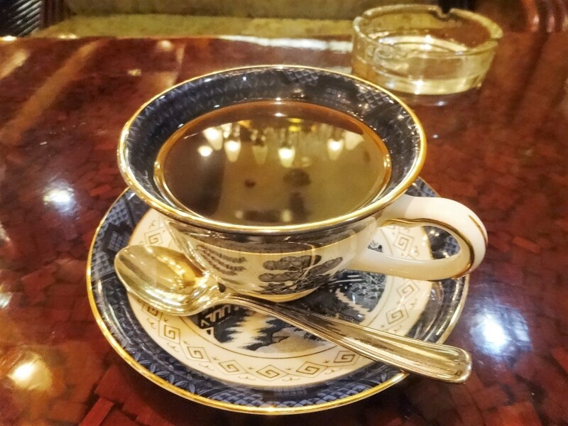 天井のシャンデリアはコーヒーに映りこんでいる