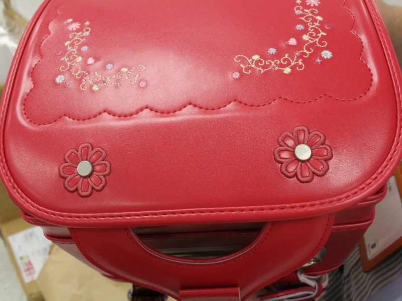 かぶせの刺繍だけでなく、かぶせ鋲に施されたフラワーアップリケが超キュート! このかわいさに、お子さんはもちろん、お母さんもメロメロです