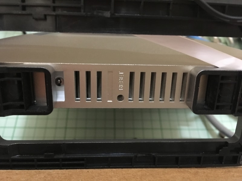 BuffaloのWSR-2533DHPは、本体裏面中央にリセットスイッチがある。本機種の場合は、クリップを伸ばしたもので、内部のスイッチを数秒押す。