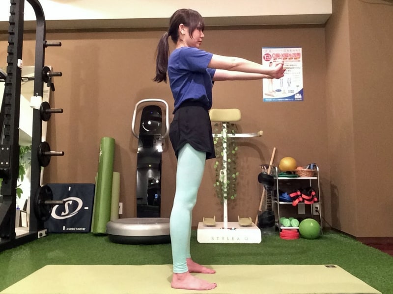 動作1. 足を肩幅に開き、両手を前に伸ばします。
