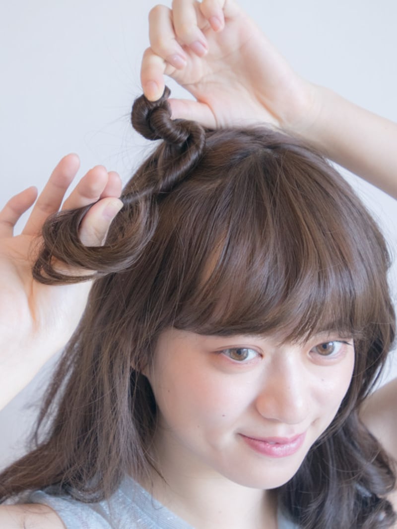 片方の手でおさえて巻きつけていく