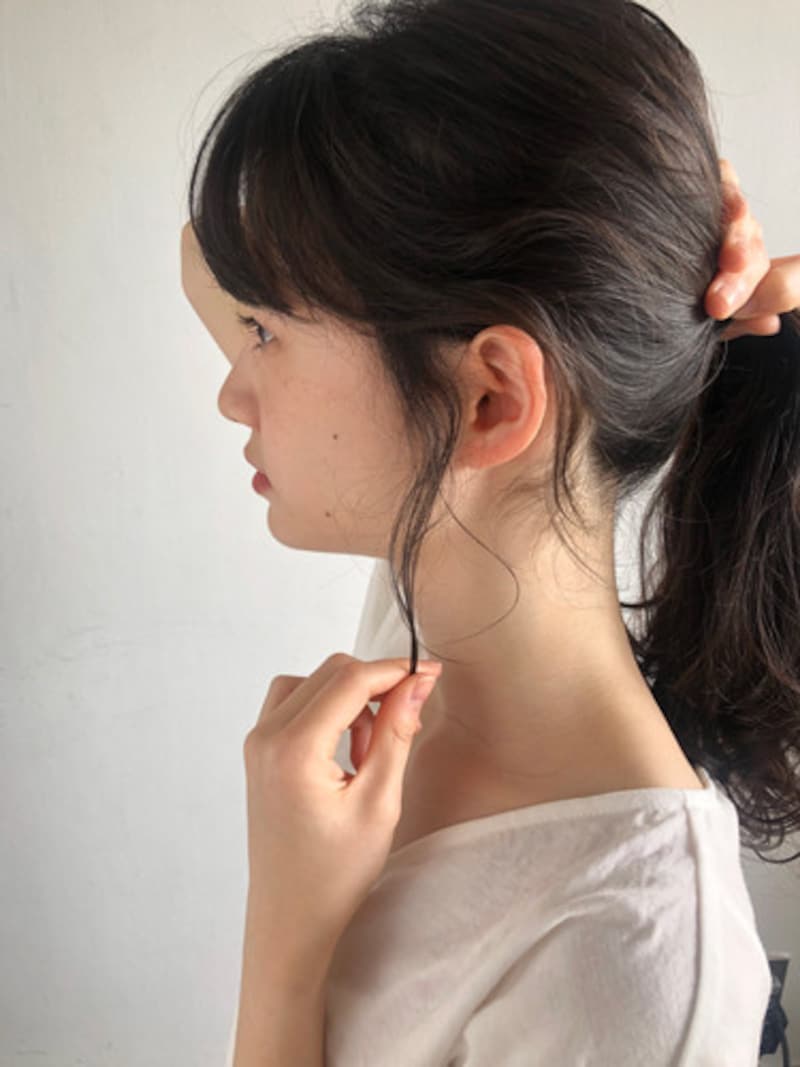 指先でつまむようにもみあげの毛束を落とし、後れ毛にする
