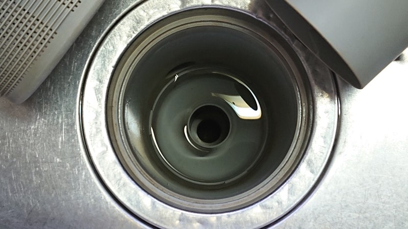 排水口ストレーナーの奥にある排水管の蓋もを外すと排水管そのものが出現!その周りや排水管の入り口も掃除を。ここまでが臭いや詰まりの元凶です。