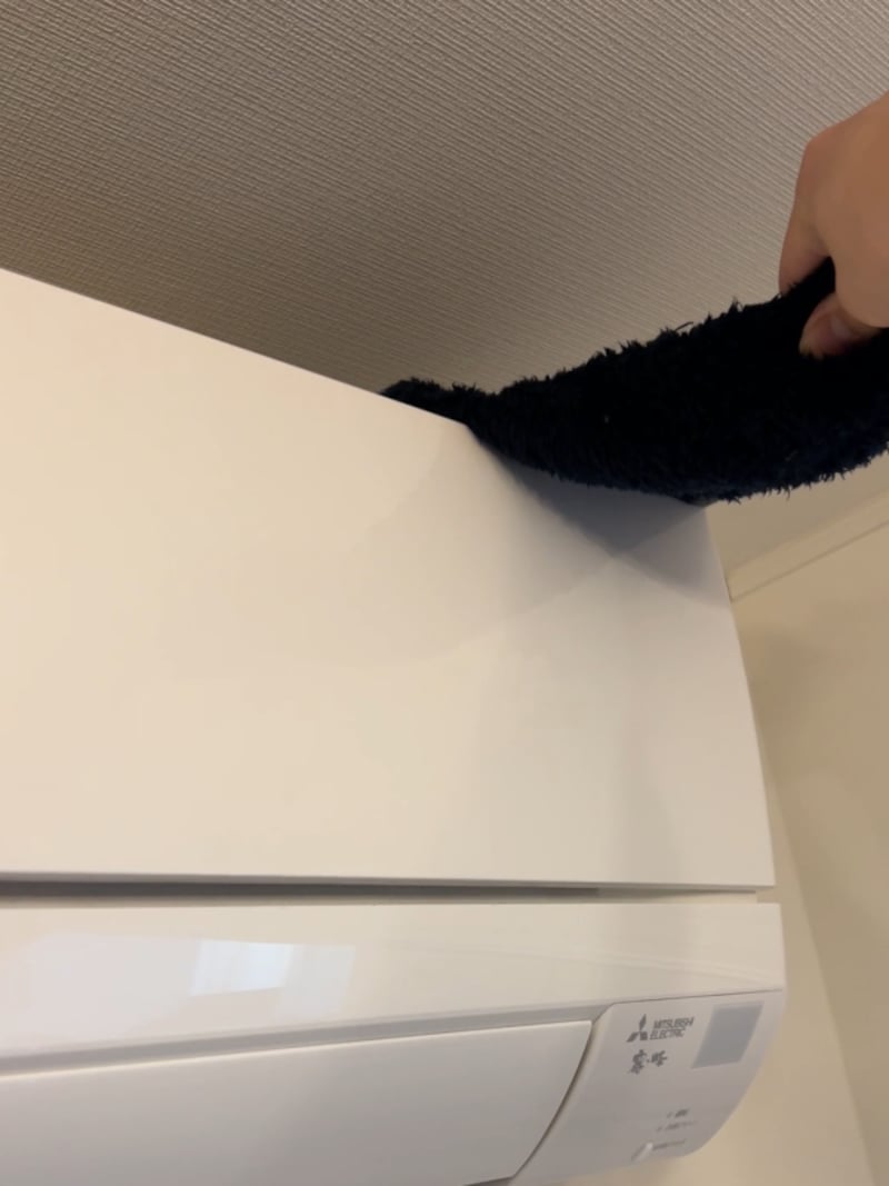 フリースの袖を活用した隙間ブラシでエアコンの上を掃除