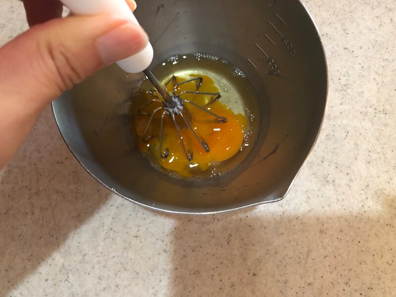 キャンドゥの「回転式ホイッパー」を2回動かしただけで、卵が形を崩していく