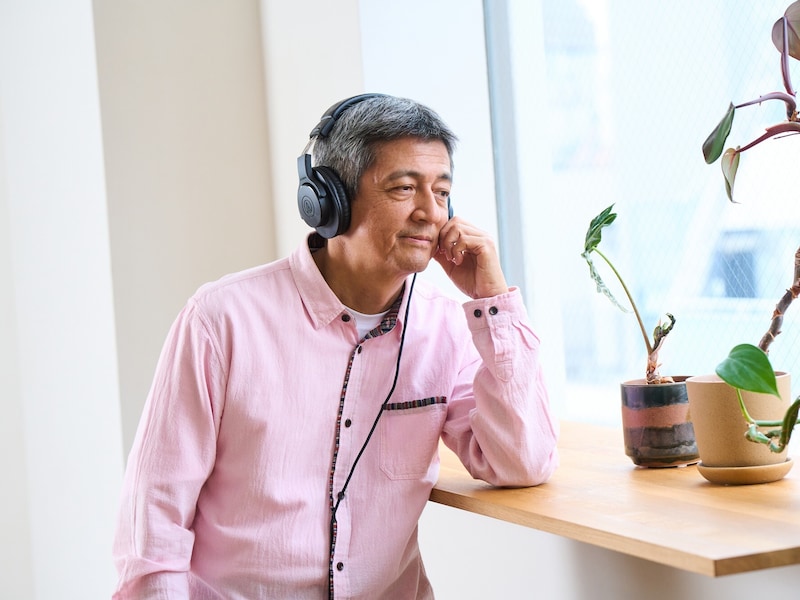 ヘッドホンで音楽を聴く男性