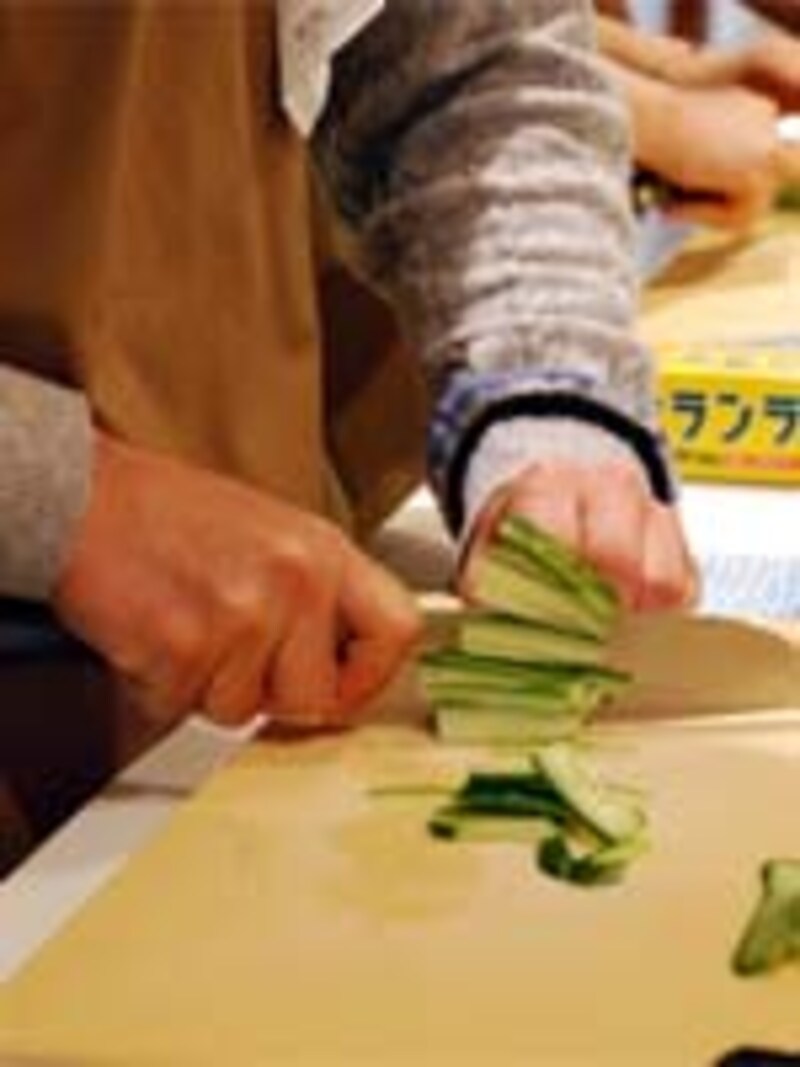 キュウリを切る男性