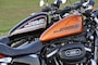 奥の黒いXL883Rは2008年式、手前のオレンジXL883Rが2015年式。2008～2010年モデルはバイクの頭脳となる「ECM」というコンピューターがシート下に設置されていてカスタムしづらい、というデメリットが潜んでいる
