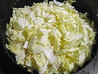 鍋に白菜の茎の部分をまず敷き、その上に油揚げとまいたけ、さらに白菜の葉の部分を重ねます。昆布茶を溶いたお湯と料理酒を加えてフタをして弱めの中火にかけます。