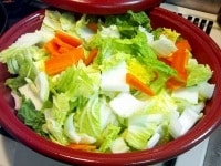 白菜はざく切り、大根、にんじんは短冊切り、長ねぎは5cm幅程度に切り、タジン鍋に入れ、昆布を野菜の中に押し込む（下に敷くと焦げる可能性がある）。全体に塩ひとつまみを振る。 <br />