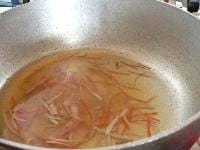 鍋に、固形コンソメ、水、細く切った野菜とベーコンを入れて煮て、コショウをふる。
