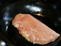 鶏肉に重量の1％程度の塩をまぶす。フライパンに油を入れて強めの弱火にかけ、皮目から鶏肉を入れる。<br />