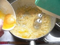 卵を一個ずつ加えていき、そのつど、中速のハンドミキサーで混ぜる。同様に、牛乳とバニラエッセンスを加えて混ぜる。