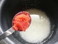 米を釜にあけ、酒を加え、規定の線まで水を入れ、辛子明太子を加えて軽く混ぜる。