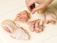 鶏肉は6等分に切ります。鶏肉の肉側（皮ではない方）へ、約1.5センチの深さの切り込みを2、3本入れます。鶏肉全体に、塩こしょうをふります。<br />