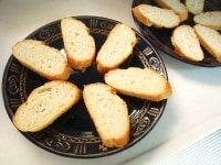 フランスパンを1cmの厚さに斜めにスライスし、盛り付ける皿に並べておきます。<br />