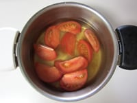 鍋にコンソメ、水、トマトを入れる