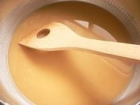 ウーロン茶と片栗粉を鍋に入れてかき混ぜて溶かす。中火にかけ、木ベラでかき混ぜながら加熱する。<br />