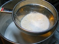 この液（呉と言う）をザルで漉します。ザルに残るのがおから、乳白色の液体が生豆乳です。ザルに残ったおからをさらにお玉や皿の底でぎゅーっと押して、豆乳をさらに搾り出します。<br />
<br />
このおからに水を加えてもう一度ミキサーにかけ、ふたたび漉し、さらに豆乳を搾り出します。<br />