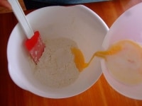 粉類と砂糖を混ぜ合わせたところに、牛乳と卵を加え、更に練乳も加えて良く混ぜ合わせます。<br />