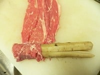 牛蒡のタコ糸を切り、できるだけ元の丸い形になるように整え、牛肉で巻いて行く。