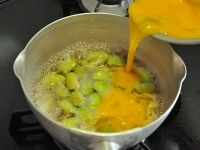 火加減は中火のまま、しっかり沸いた煮汁の中に、よく溶いた卵を流し入れます。