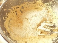 ホットケーキミックスを広げて入れ、ミキサーの低速で混ぜ、粉っぽさが少し残っているくらいで、ゴムベラに持ち替える。<br />