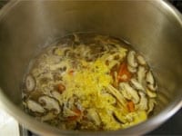 圧力ピンの降りた圧力鍋に大根、にんじん、しいたけ、たけのこをを入れ、火にかけます。野菜に火が通ったら、鶏がらスープの素と塩で味を整え、ごま油で香りをつけ、溶き卵を散らします。