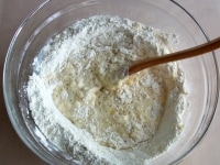 スプーンでくぼみの内側を少しずつくずすように、粉と牛乳を混ぜる。