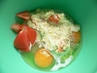 ポテトサラダ、適当に切ったトマト、卵、粉チーズ、牛乳、コショウを混ぜる。<br />