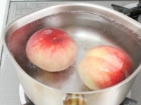 桃を湯むきする。沸騰した湯に20～30秒入れて冷水に取り、皮をむく。レモンは白いわたの部分まで皮をむき、輪切りにする。バニラビーンズは縦に切れ目を入れる。