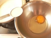 温まった豆乳スープを、大さじ1すくい取って卵に入れてしっかり泡立てる。
