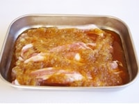 玉ねぎをすりおろし、醤油・みりんと混ぜ合わせたつけだれを作り、豚肉をひたし、5分ほど置きます。<br />